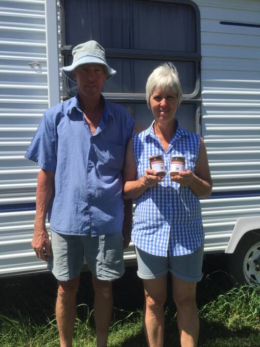 David and Alison Dinham with the caravan they lived in while they learned the ropes on Norland Fig Orchard. 