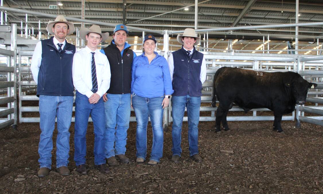 KMWL's Luke Whitty and Jack Whitty, Moogenilla Angus' Brett Stockman and Emily Sinderberry, and KMWL's Sam Parish with top priced lot from the stud's bull sale at Forbes, Moogenilla R140. Photo: Denis Howard 