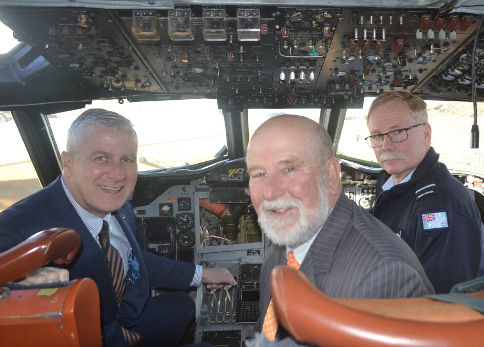 Checking out the cockpit of the P-3 are the Hon. Michael McCormack, Mayor Ken Keith and Air Commodore John Meier. 