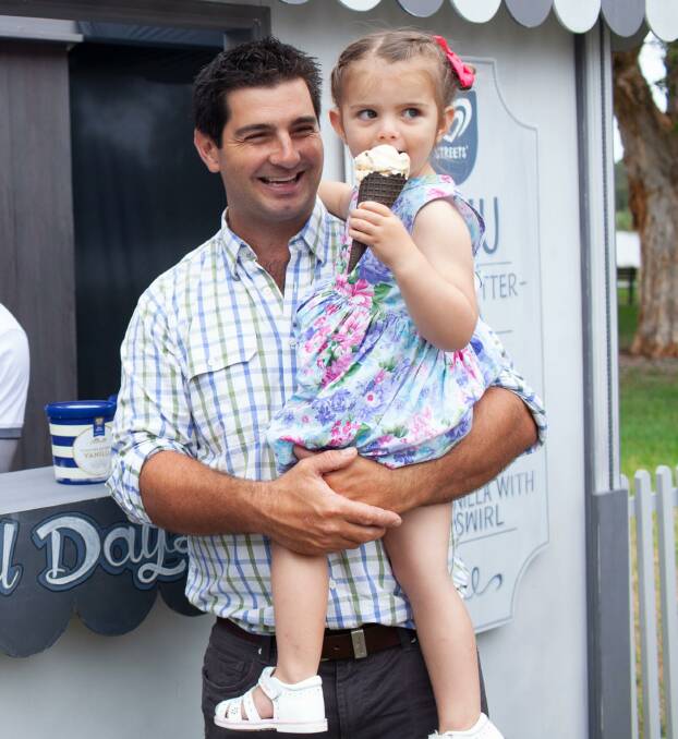 CREAMY: Fourth generation dairy farmer Stuart Griffin and his daughter Eloise enjoy some ice cream at an education day in Sydney. 