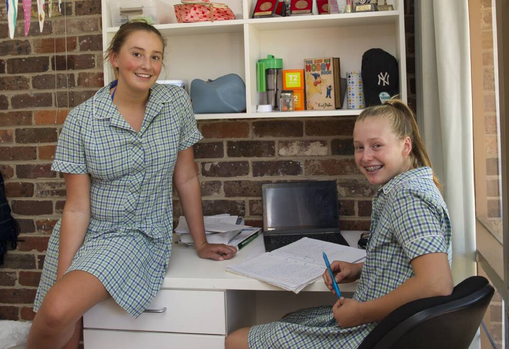 Geelong College's 2018 girls boarding captain Olympia Binos helps another student study.