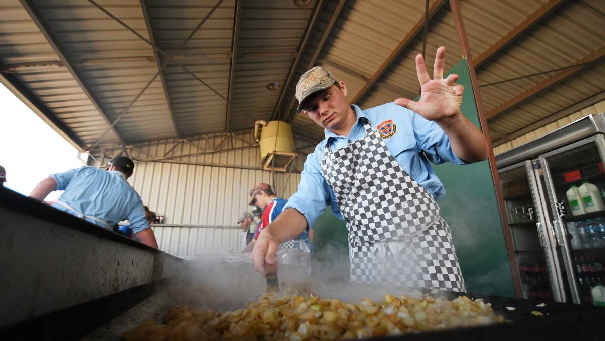 All in the wrist: Cooking steaks and onions has become an art form at AgQuip over the years. Photo: Gareth Gardner