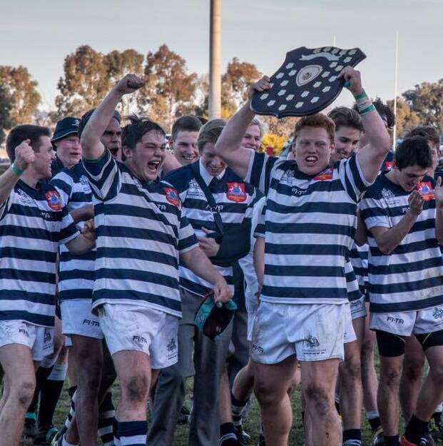 Stannies rugby captain Bo Abra lifting the ISA rugby union trophy with his teammates. The team completed the 2017 campaign unbeaten. 