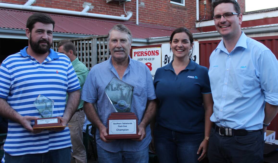Daniel and Brad Cartwright, "Kempton", Crookwell, being presented with their trophies for winning the Southern Tablelands Flock Ewe championship by Adele Fiene and Andrew Treweeke, ANZ Agribusiness. 