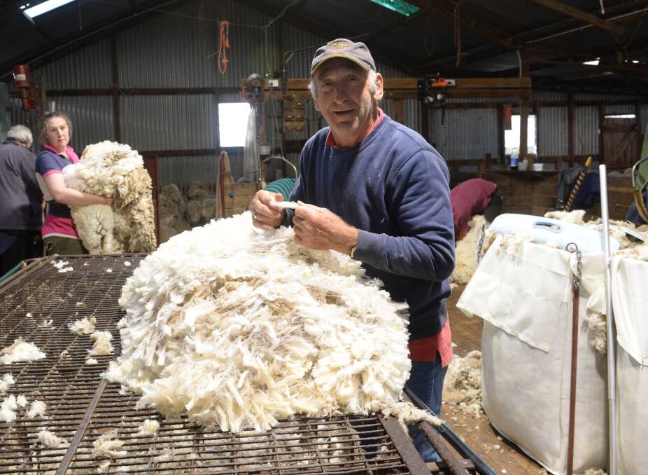 John Stephens, now 79, classing wool in a shearing shed near Boorowa. He started in the shearing industry as a lad of 15 back in his home town of Warren. Picture by RACHAEL WEBB.   