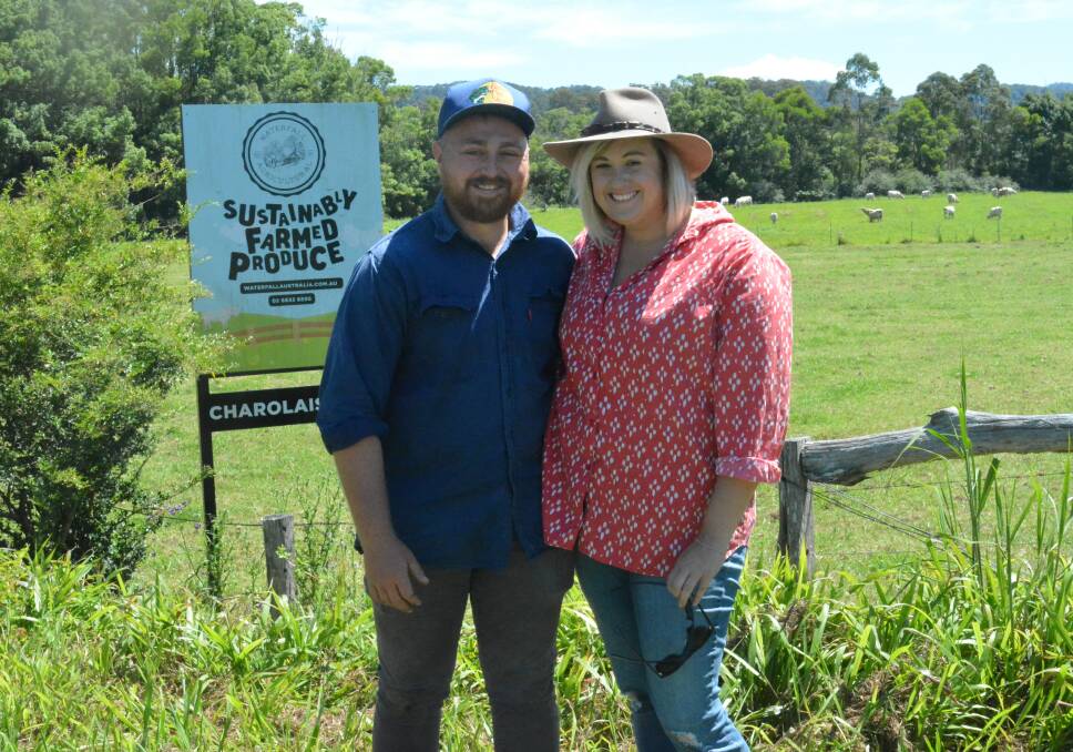 Troy Blackman and his partner, Hannah Newnham, stand in front of one of the paddocks where stud Charolais cattle are rotated with chickens for organic egg and beef production.      