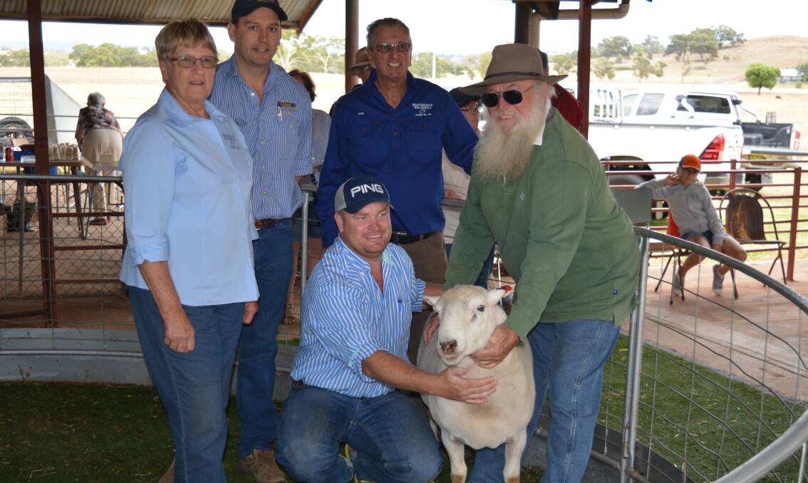 Loris Denyer with auctioneer, Andy Carter, McDonald Lawson, Mudgee, Ian Hopwood, Reavesdale Wiltipoll stud, Murringo, Stuart Beckett, Maules Creek, with his son, Marty, holding the top price ram.   