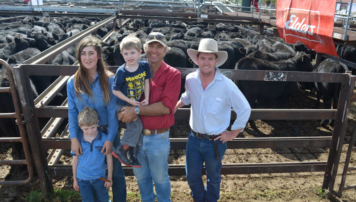 Ben Foley, Wheeo, with his daughter Tess and sons Angus and Bryce, sold 28 Angus steers for $1000 to Dougal Kelly, “Wallah”, Rugby (right).