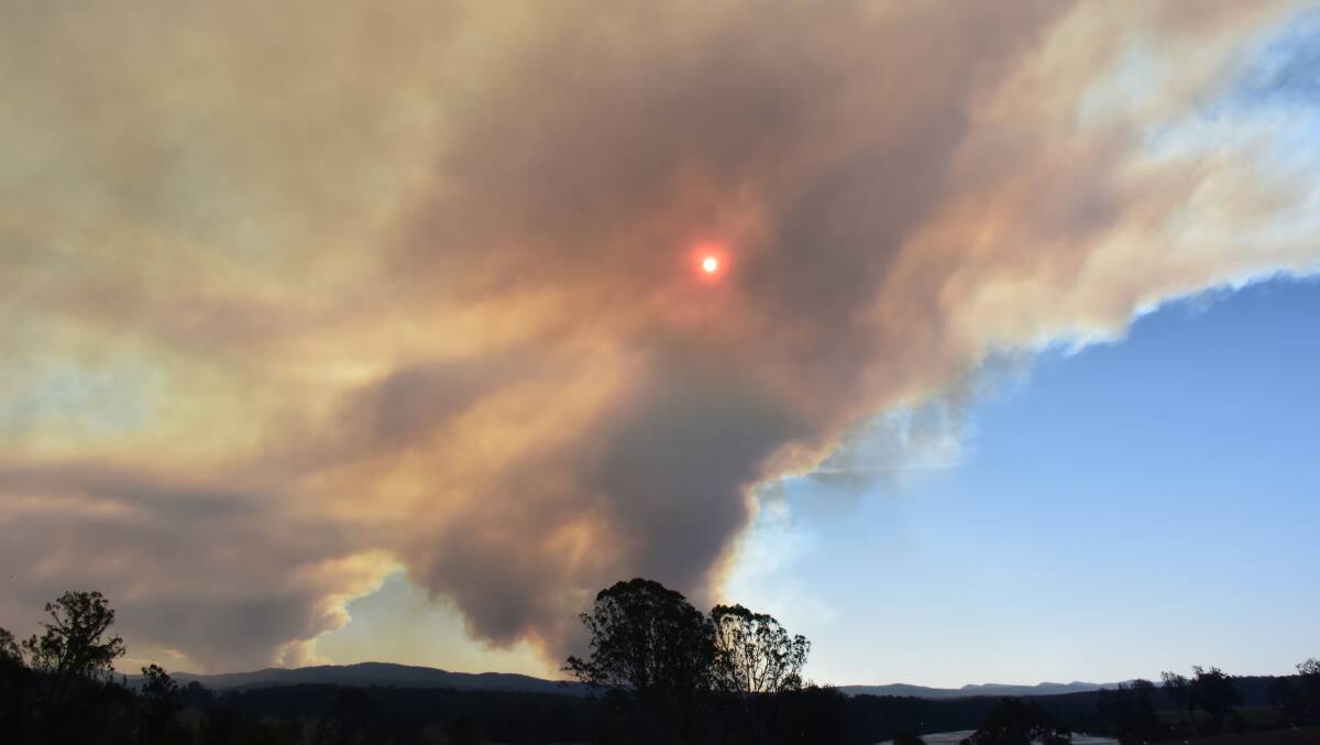 Fires at Tenterfield, left, and at Long Gully near Drake, fanned in earnest on Friday under gusty and changeable winds.