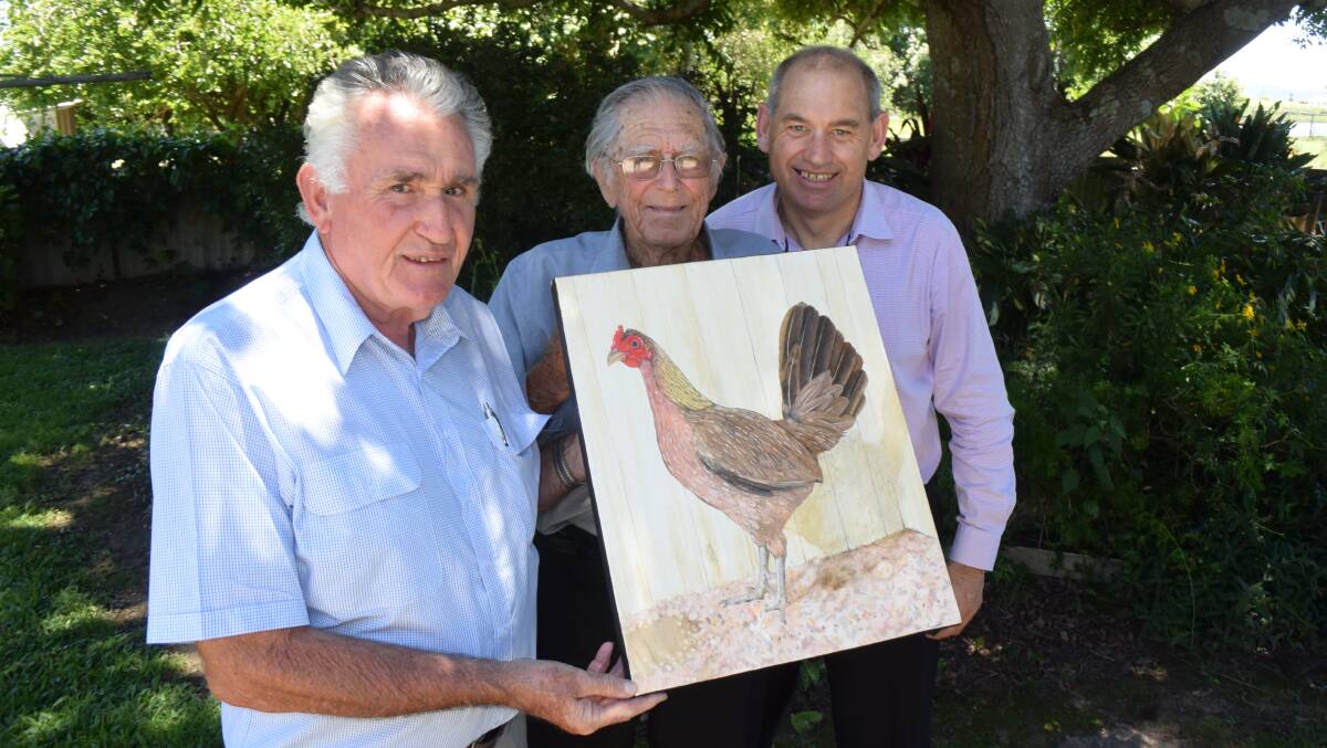 Far North Coast All Game poultry club president John Gibson and secretary Steve Dubber present Ray Connors with a portrait of his prize hen.