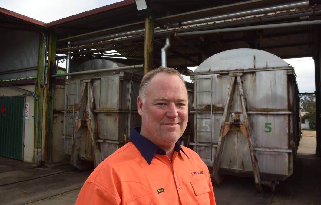 Jonathon Bryant in front of 11 tonne tea tree biomass bins being injected with steam to distill out their essential oils. Each bin produces more than 100kg of oil.