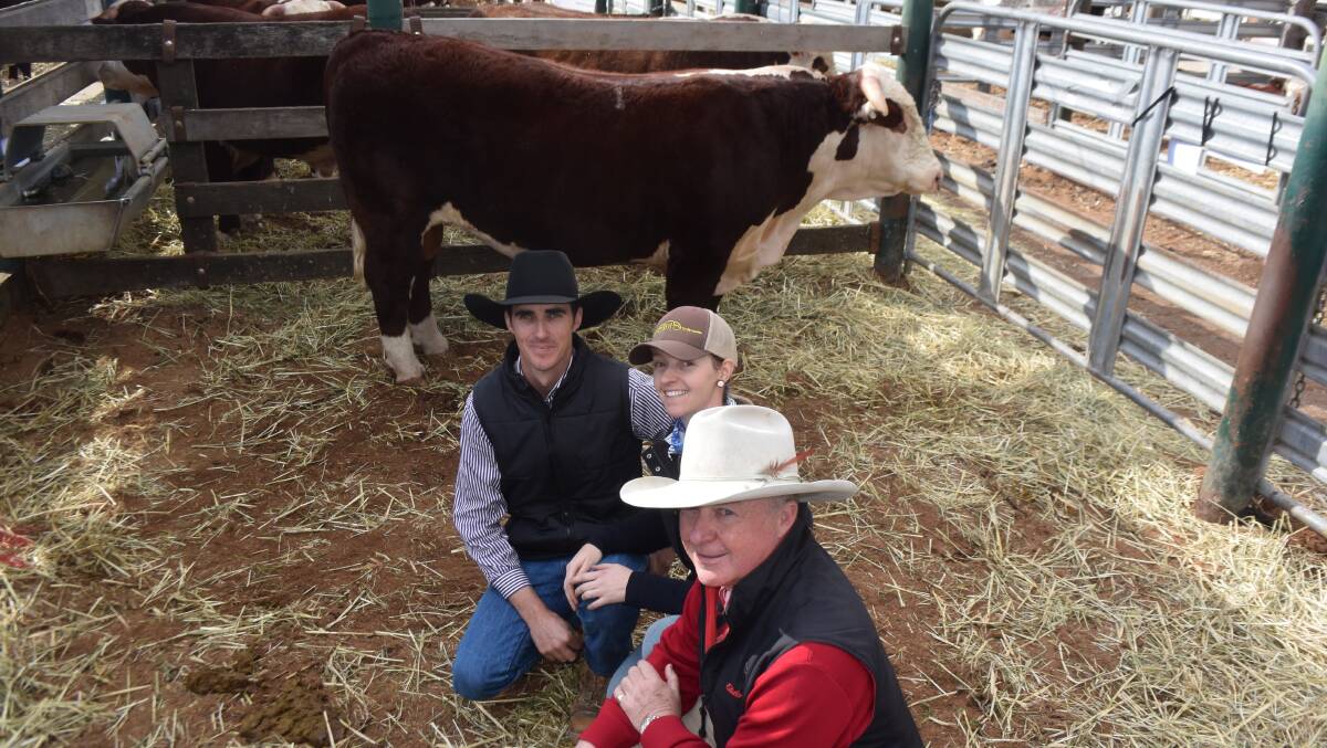 Grant and Kylie Kneipp, Battalion Herefords, Dundee, with Elders auctioneer Andrew Meara in front of top priced bull at the Glen Innes Hereford bull sale, lot one Battalion Undertaker M023 which sold for $20,000.
