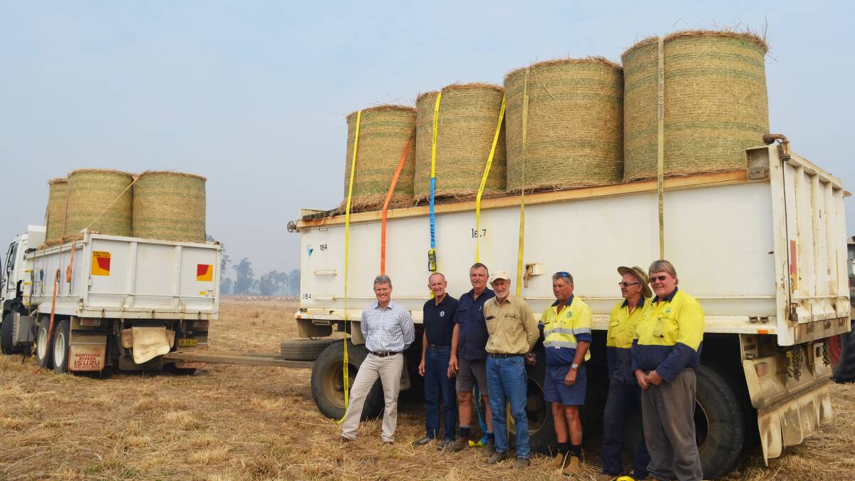 From the coast to the plains: Richmond Valley Council general manager Vaughan Macdonald, Mayor Robert Mustow, Kelvin Hamilton, beef producer John Fitzhenry - who donated the hay - Tony Simpson, Noel Clarke and David Attewell before Friday's convoy headed west to Narrabri.