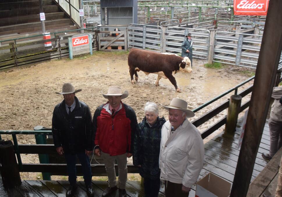 Kylandee principal Phil Thomas, Elders auctioneer Lincoln McKinlay and top bull buyers Shirley and George Hardcastle, McPherson Herefords at Old Koreelah after a wet and cold sale at Glen Innes on Friday. 