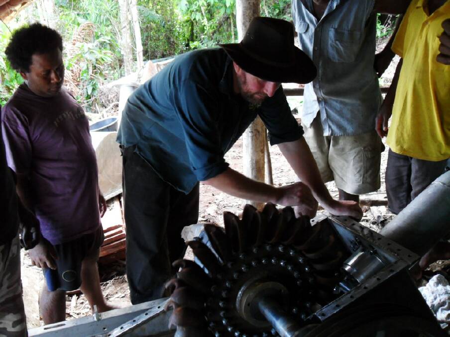Peter Lynch of Pelena based at Dorrigo inspects a pelton wheel off a small scale hydro-power scheme in the Solomon Islands. This same technology has been under utilised in eastern Australia where stream flow is powerful enough to drive down power bills,.