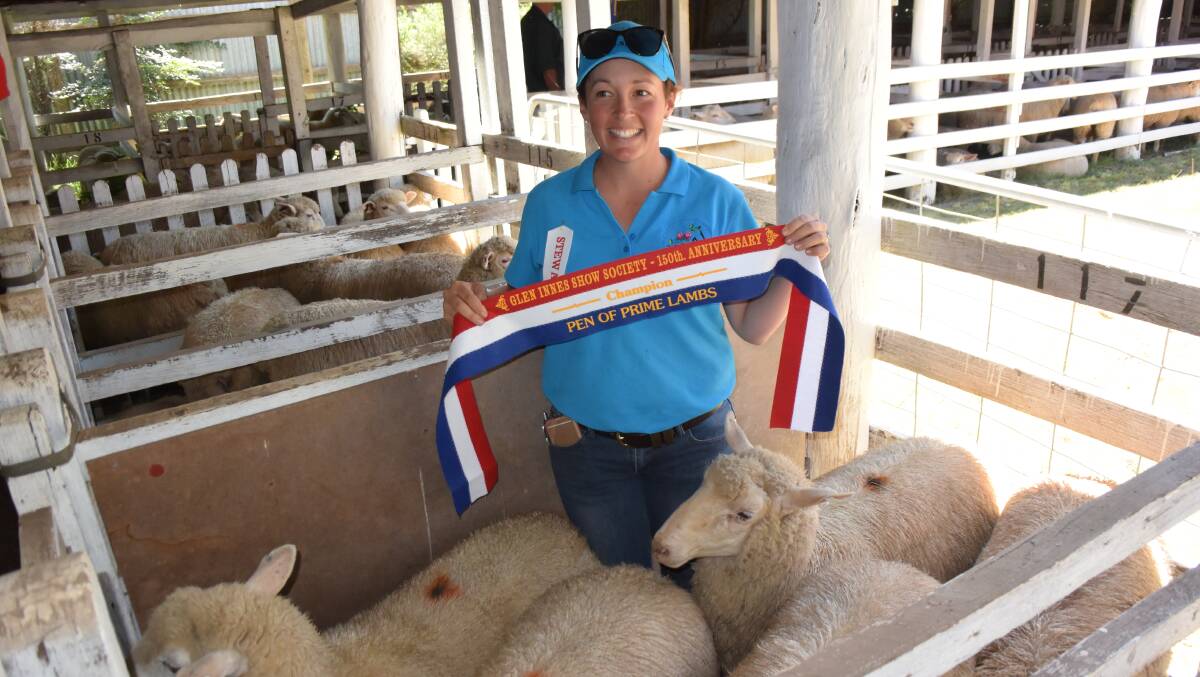Emma Walmsley with her champion pen of second cross prime lambs as judged by Roger Fletcher at the 150th Glen Innes Show.