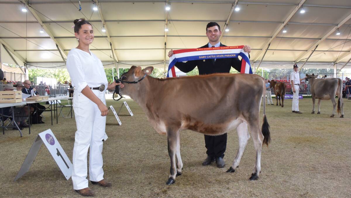 NSW champion dairy parader at the Sydney Royal Show, Elly Simms from Nowra, presented with the champion ribbon by Manning Valley judge Cameron Yarnold.
