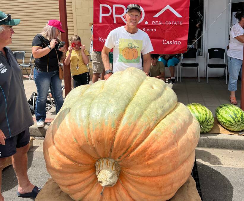 Tintenbar nurseryman Dale Oliver with his 674.5kg Giant Atlantic variety pumpkin at Kyogle on Saturday. Photo by Lillian Cox.