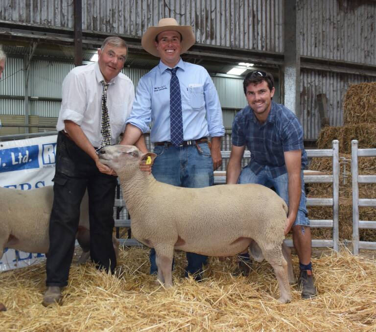 Camlea stud principal Kevin Feakins, Glencoe, with the top selling ram of the sale bought by Daniel Hooper, "Vortex" Banalla, Victoria, pictured with auctioneer Shad Bailey, centre, with Colin Say and Company Glen Innes.
