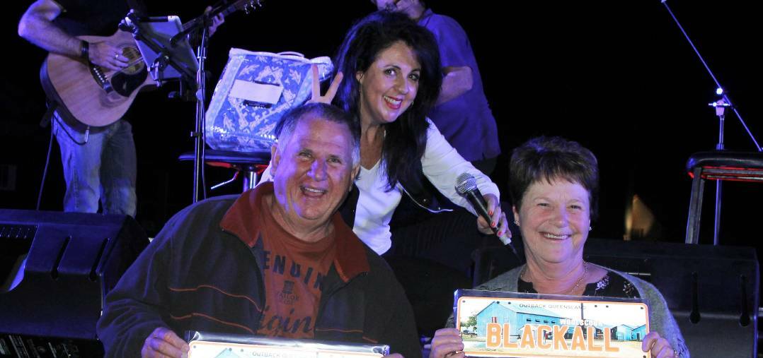 Tania Kernaghan loves meeting her fans, like Neil Fisher and Diane Benson during a Blackall Queensland country music concert.