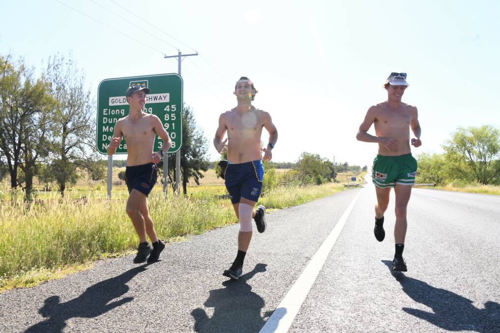 Dubbo boys Matt Bridges, Cameron Longhurst and Connor Etcell run down the Golden Highway into Dubbo to raise money for the Black Dog Foundation. Picture by Amy McIntyre