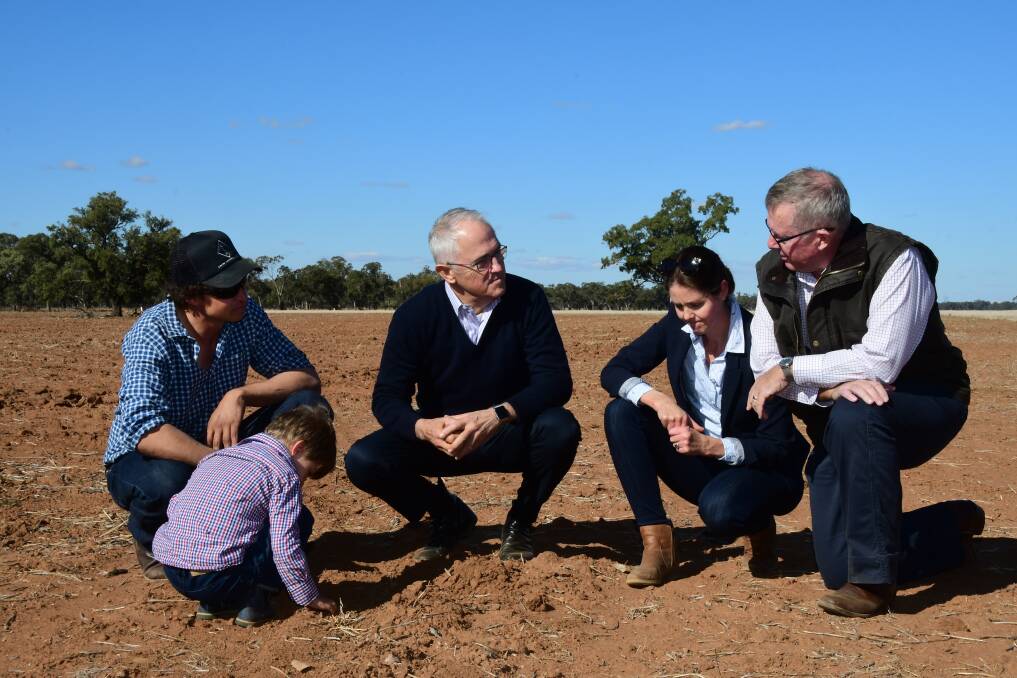 DRY TIMES: Farmers Phil and Ashlea Miles and son Jack with Prime Minister Malcolm Turnbull and Parkes MP Mark Coulton. Photo: BELINDA SOOLE