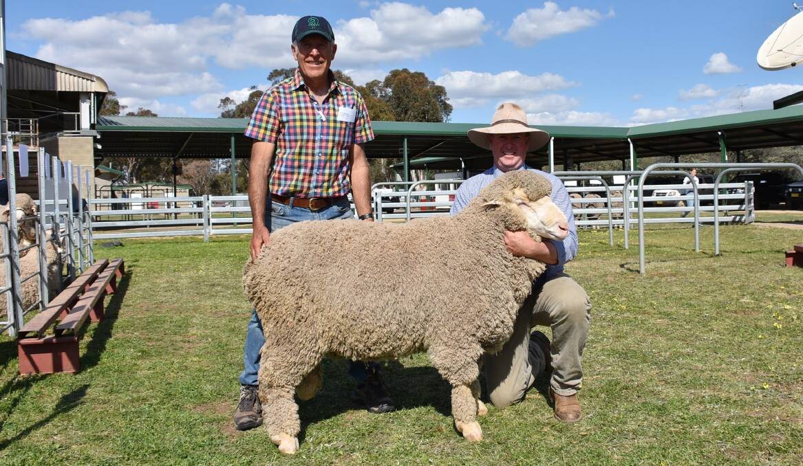 Adam Mort, Hilltop Merino Stud, Mudgee with Woodpark Poll's Stephen Huggins and his $6000 top price ram purchase WP170273.