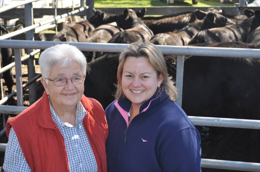 Lorraine and Amanda Sutton, Gilmore, with their pen of 20, 11-month-old Angus steers which sold for $990 a head at Tumut on Wednesday. 