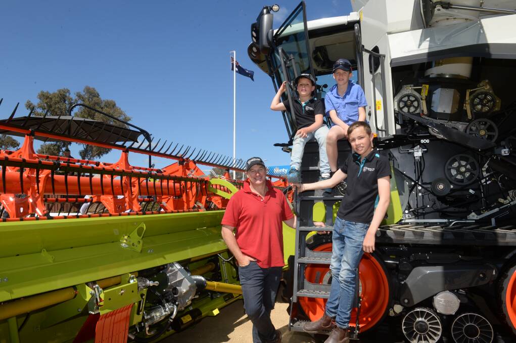 Rod Frohling, Oak Hill, Burrumbuttock checking out the new Claas header with William Frohling, 7, Daniel Knobel, 10, Alma Park and Joshua Frohling,13.
