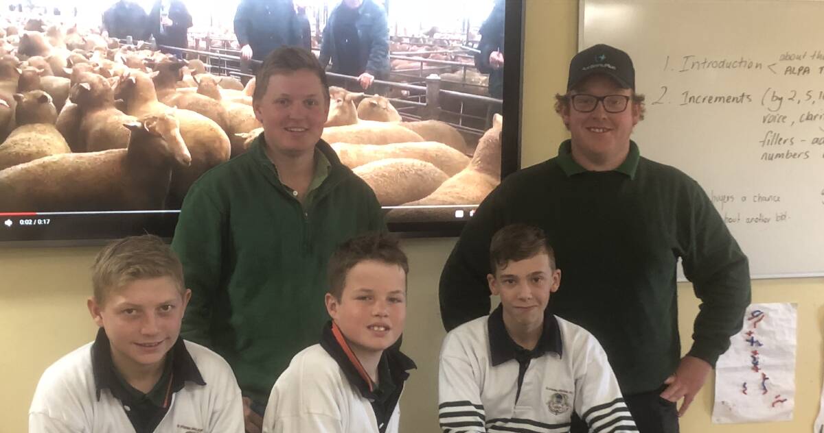 The Riverina Anglican College students, Tom Marcantelli, Henry Roberts and Lachie Garnock learn from Landmark auctioneers Ned Balharrie and Jim Binks. Photo: Nikki Reynolds