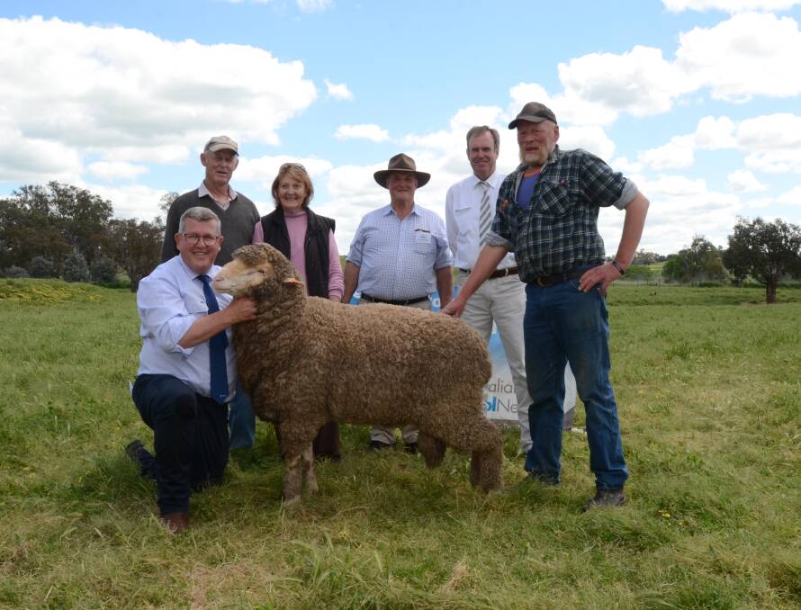 The top priced ram, purchased for $7500 by Ray and Sandra Neville, Cowra. Also pictured, Mark Taylor, Australian Wool Network, Kim Henderson, Groganswoth, auctioneer Paul Dooley and Bruce Bingley, Athlone, Berremangra.
