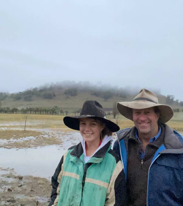 Jim Feilen, Merrigang, Bombala, with daughter Hannah. The Feilens have recorded 100 millimetres in the past couple of days. Photo: Supplied