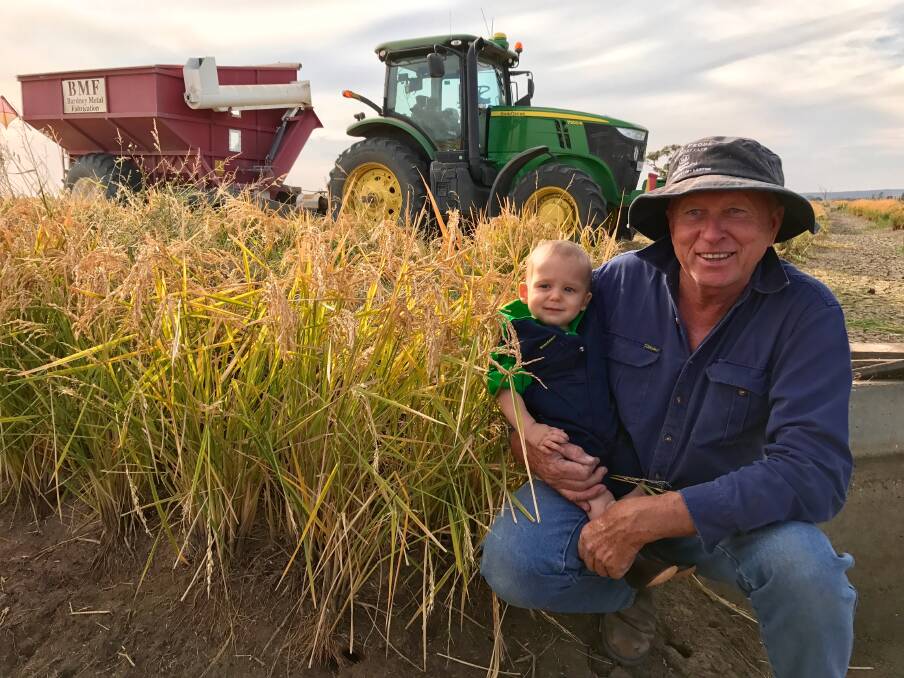 Peter Draper with his grandson Ashton enjoying the rice harvest. The Drapers were named SunRice Growers of the Year 2020. Recently they have focused on improving their water efficiencies with a new irrigation layout. Photo: Supplied