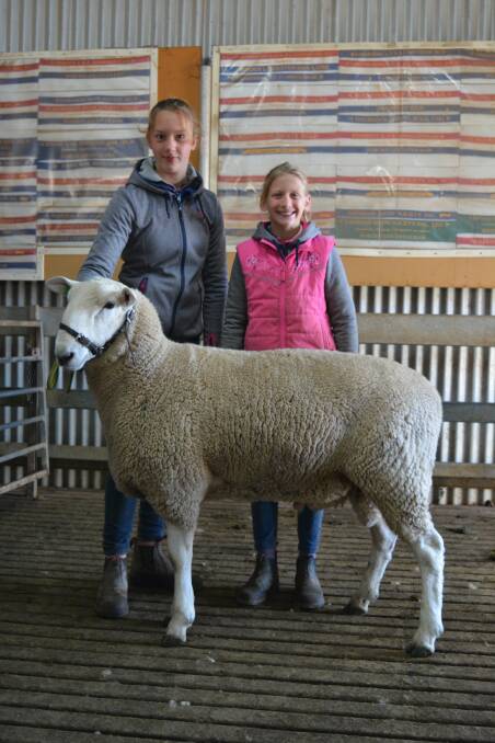 Elizabeth and Christine Sutton, Wattle Farm with the top priced stud ram of the sale, purchased by Talkook Border Leicesters, Crookwell for $4500. Photo: Supplied 