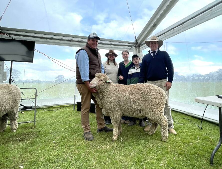 One of the equal top-priced rams with Craig and Karen Wilson, representing buyers Jimenbuen Pastoral Company, Dalgety, with Olivia, Digby and Stephen Huggins, Woodpark Poll, Jerilderie. 