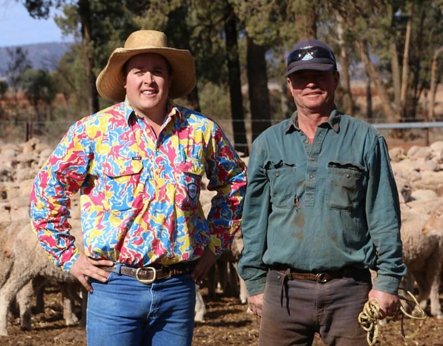 Livestock agent Brendon White, with farmer Phil Harding from Brooklyn, Condobolin. Brendon said wearing his TradeMutt work shirt during the drought prompted many conversations on mental health. Photo: Supplied