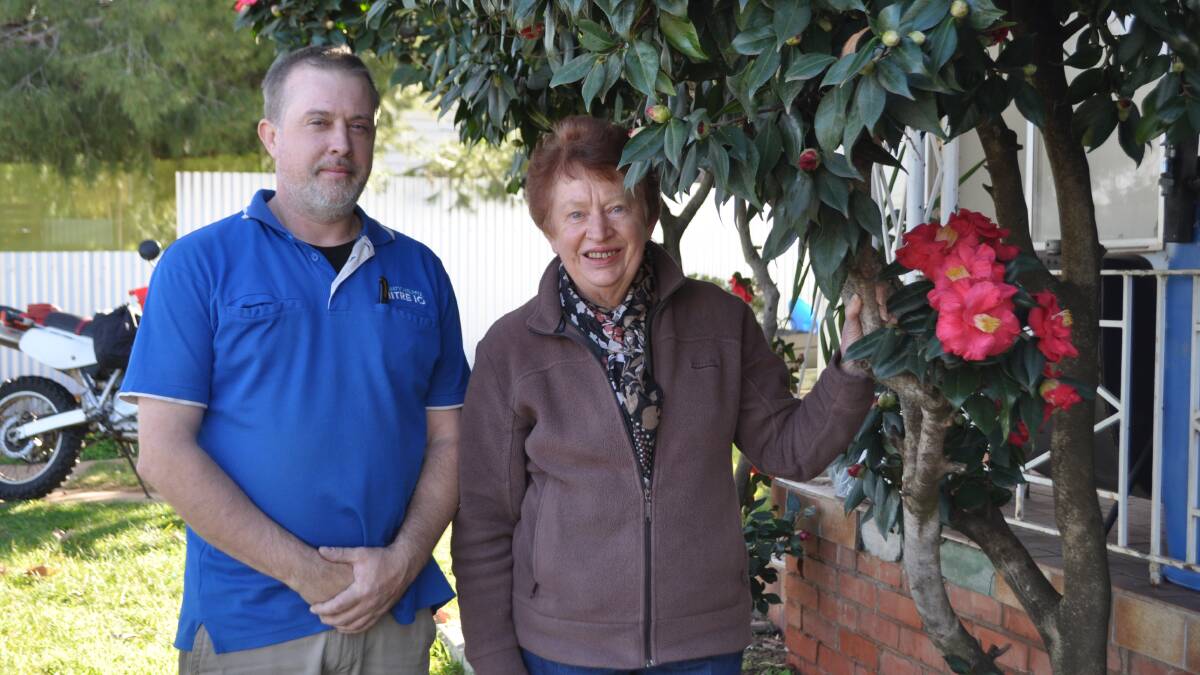 Jodey-Lee Riddell with Denise Di Salvia. Mr Riddell inherited his camellias from his home's previous owner. With the help of Mrs Di Salvia and others in the Narrandera Gardening Club he has won several first prizes.