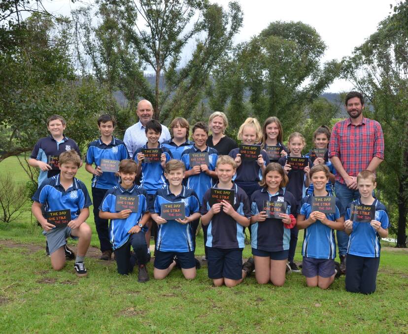 Cobargo Public School's Year 5/6 class and teacher Campbell Kerr with Littlescribe founder, Jenny Atkinson, and ambassador, author Andrew Daddo. The Cobargo students have written a book about the bushfires titled 'The Day She Stole the Sun.'