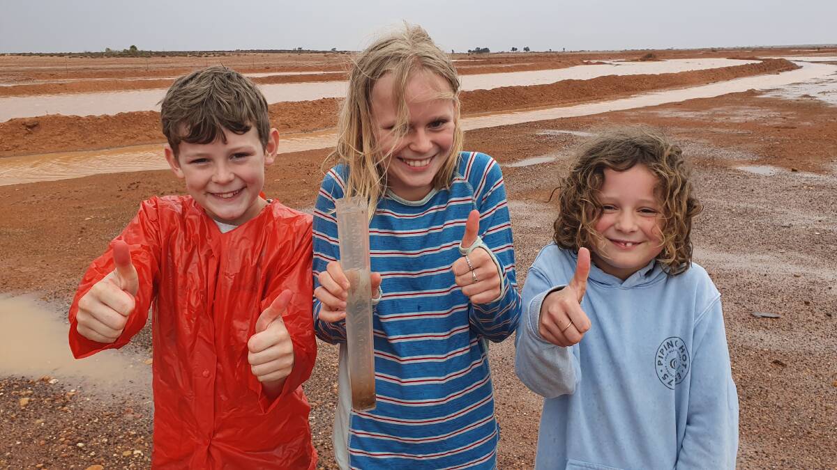 George, 10, Jess, 12 and Nicola, 8 Mashford give the rain a big thumbs up. Photo: Supplied 