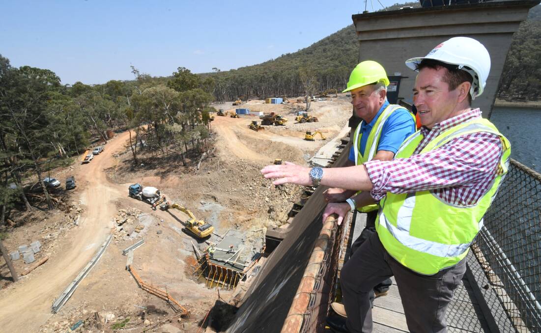 Dam Safety NSW said one of the projects identified as posing a risk to community safety was Winburndale Dam, owned by Bathurst Regional Council. Pictured, Bathurst mayor Bobby Bourke with MP Paul Toole checking out the progress to strengthen the dam wall. Photo: CHRIS SEABROOK