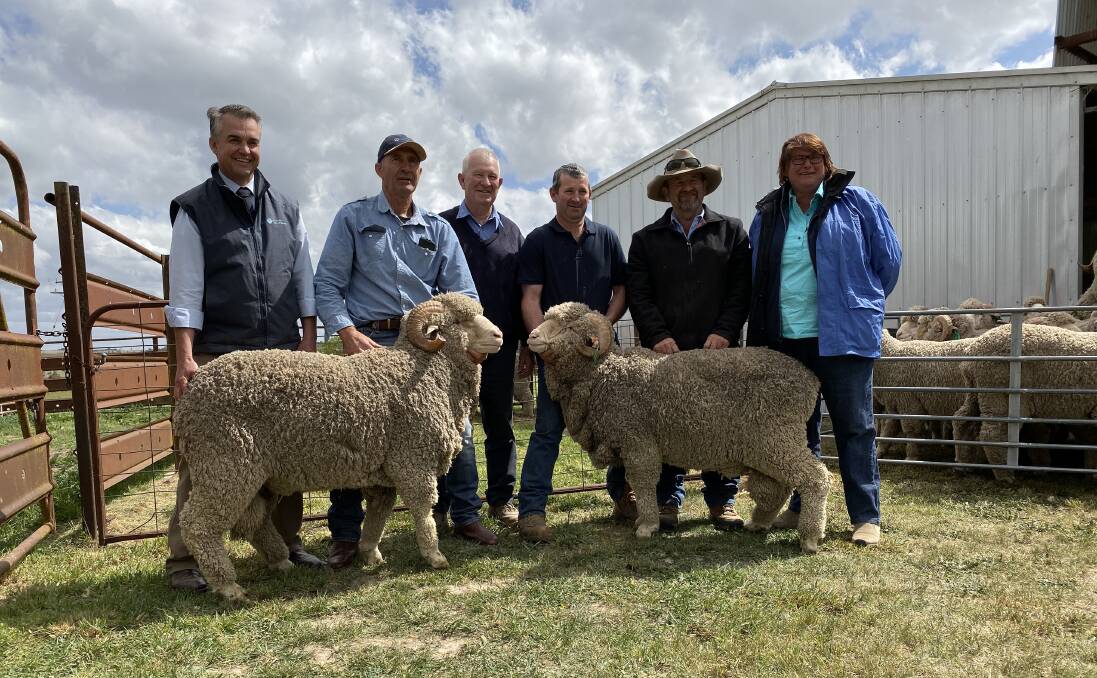 The top-priced rams with Mark Hedley, Australian Wool Network, purchaser, Brian Corby, Neville McIntosh, Ben McIntosh and purchasers, Graeme and Dianne Hewitt. Photo supplied. 