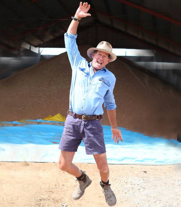 Guy Murphy, Mookoo, Garah jumping for joy with a full shed of chickpeas behind him, with 2020 bringing the Murphys their first decent harvest in years. Photo: Georgina Poole