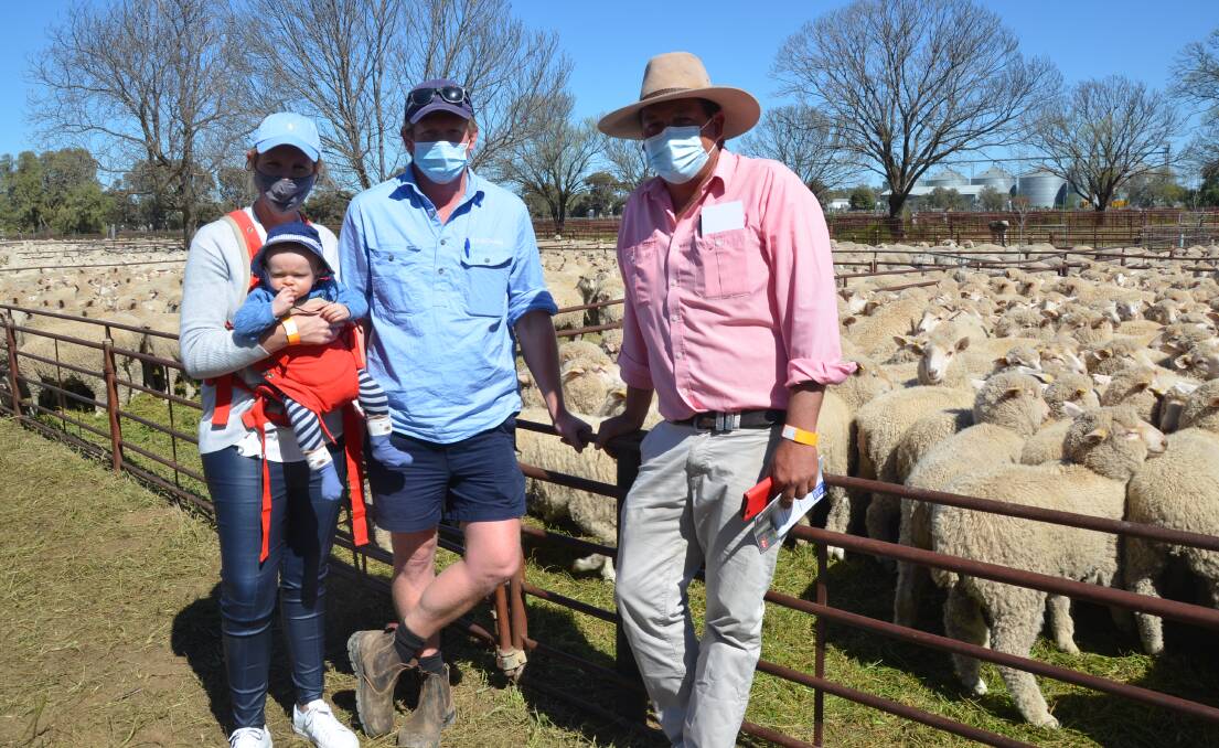 Jess, George and baby Archie Commins, Bidgee Farms, Darlington Point with agent Cameron Townsend, Elders Griffith. The Commins bought four pens of first cross wethers for a top price $178. 