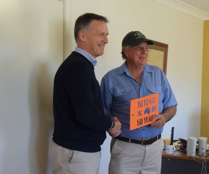 Australian Wool Exhange (AWEX) CEO Mark Grave presents Mr Yeo with the stencil. Photo: Taylor Jurd. 