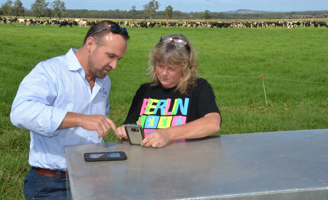 Dairy NSW regional extension officer Greg Duncan and Brundee dairy farmer Tracey Russell look at the Dairy Australia Dairy Forecast Service.