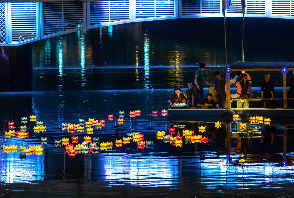 CULTURE: Buddhists floating lanterns on the river at night as a ritual prayers for everyone during the Buddha's birthday celebration in Ho Chi Minh City, Vietnam. Photo: Shutterstock.com.