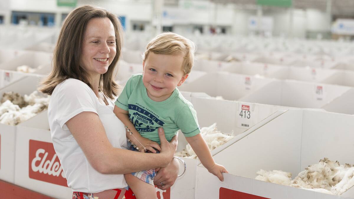 Merineo founder Claire Hausler at the Wool Selling Centre in Melbourne holding her son Jack Johnson.Photo: Barrie Turpin