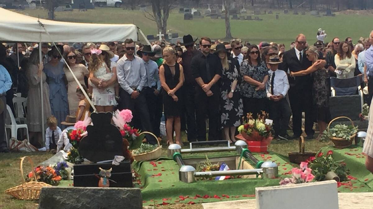 Mourners gather at the funerals for Robert and Patrick Salway on Friday.