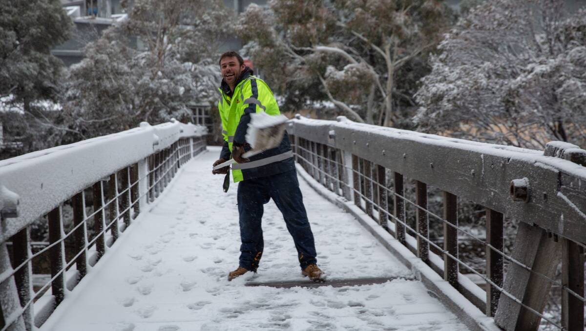 Shovelling snow, plenty of it on the bridge at Thredbo Resort as the snow season is officially launched this weekend with big dumps of snow making it a perfect start.