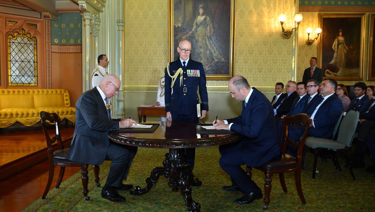 Matt Kean, at right, being sworn in as the new Energy and Environment Minister.